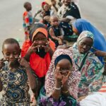 A group of children smiling and posing for the camera, embodying joy and hope through Hunger Relief West Africa’s efforts. Learn more about their stories on The Pulse of Hope blog