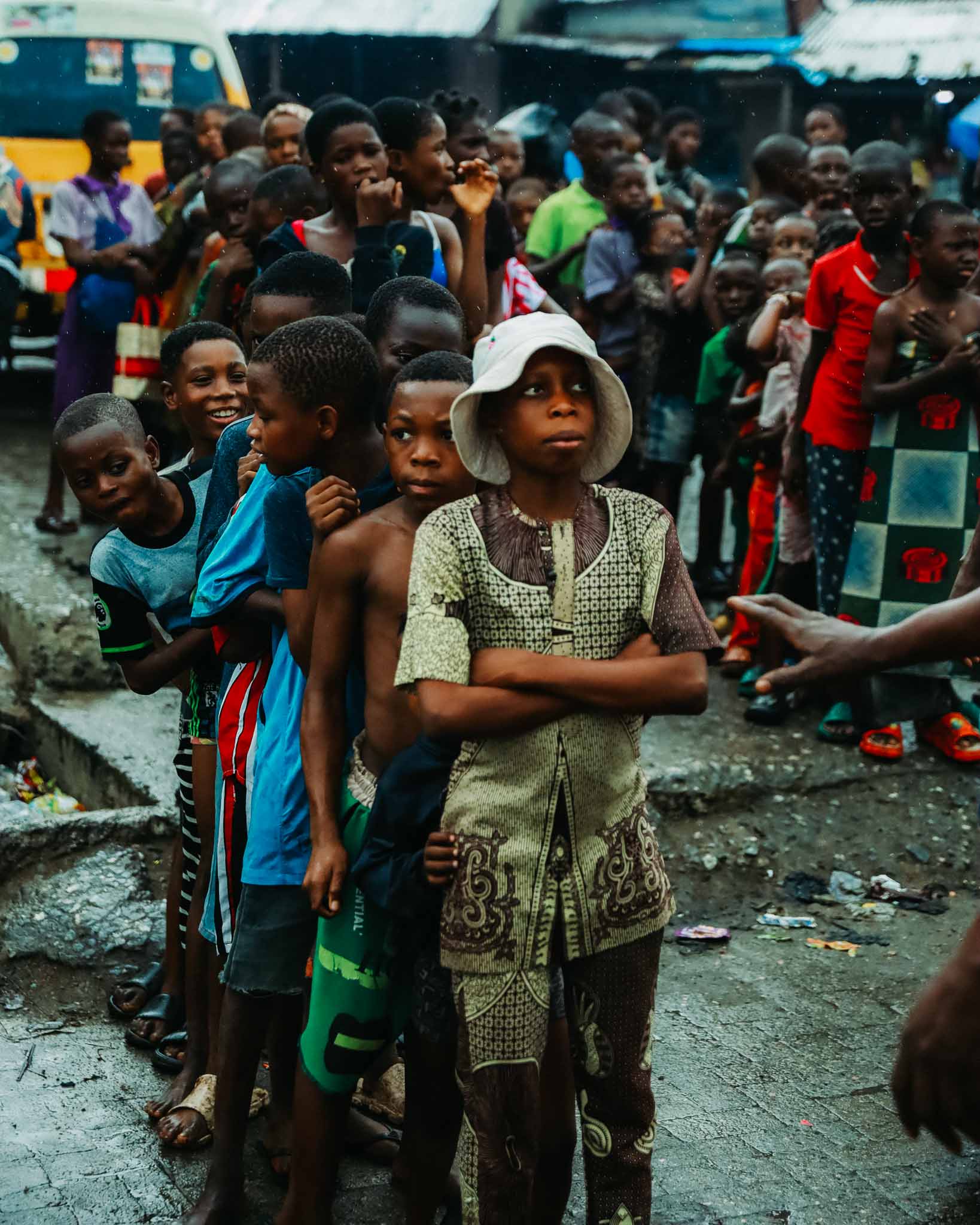 children waiting in line at hunger relief West Africa field distribution site